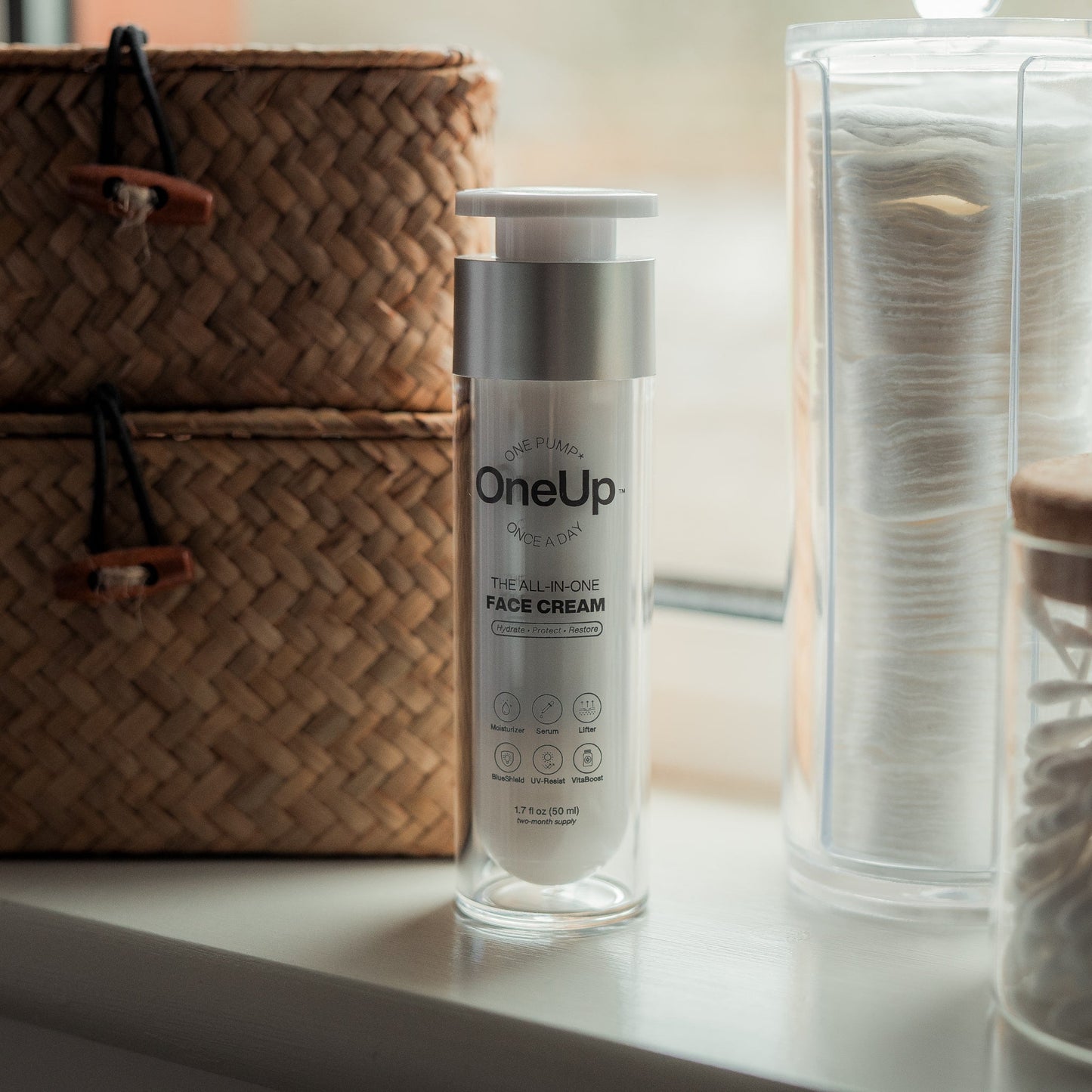 OneUp all-in-one face cream in a white and silver bottle. Hydrates, protects, and restores skin. 1.7 fl oz.