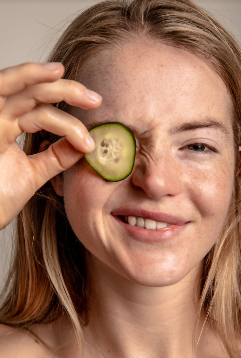 cucumber being held up to face